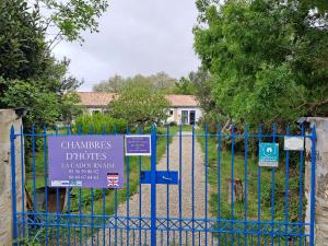 Una puerta azul con un cartel. en La Cadournaise, en Saint-Seurin-de-Cadourne