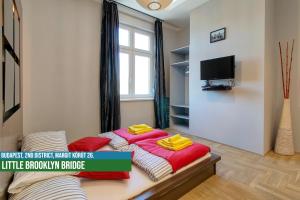 a bedroom with a bed with two towels on it at Little Americas Hillside Apartments in Budapest