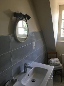 a bathroom with a sink and a mirror at A 2’ du port & du bourg maison spacieuse in La Trinité-sur-Mer