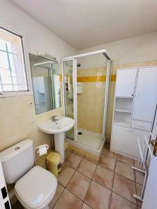 a bathroom with a toilet and a shower and a sink at Petite villa au calme dans résidence avec piscine in Fréjus