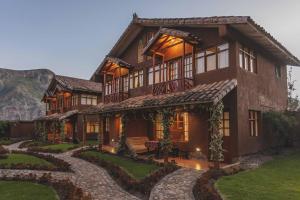 a large house with a pathway leading to it at Kutimuy Lodge in Urubamba