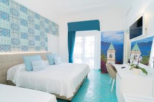 Postel nebo postele na pokoji v ubytování Hotel Miramare