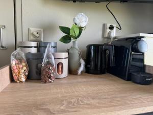 a kitchen counter with a coffee maker and some food at Hotelhuisjes Medemblik in Wieringerwerf +26 photos