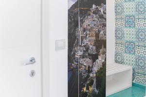 a room with a window with a picture of a city at Hotel Miramare in Maiori +89 photos