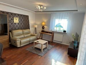 uma sala de estar com um sofá e uma mesa em Apartament Nad Zalewem em Rzeszów