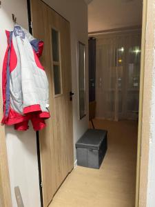 a door to a room with a bag and a stool at BROWARNA apartamenty Tanie Spanie in Elblag