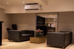 a living room with two chairs and a couch at Ribai Hotels Santa Marta in Santa Marta