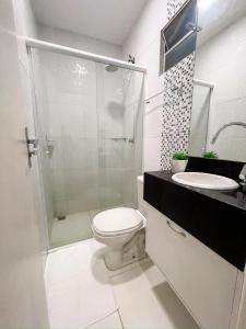 a bathroom with a shower and a toilet and a sink at Pureza Hotel in Timon