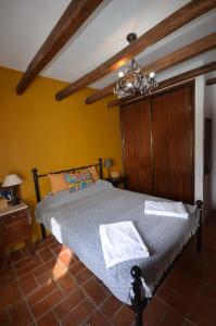 a bedroom with a bed and a chandelier at Casa Fernanda in Fuzeta