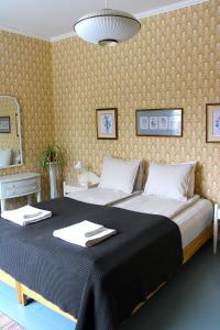 een slaapkamer met een groot bed en handdoeken bij Vinter Bed & Breakfast in Sauvo