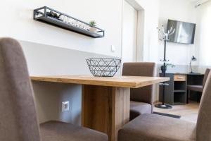 a room with a table with chairs and a shelf at Apartment 4you in Oberpullendorf +5 photos