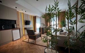 a living room with potted plants and a couch at Shiboo Suite Otel in Gebze