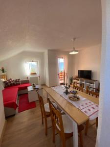 a kitchen and living room with a table and chairs at Apartman Kremen in Kuterevo