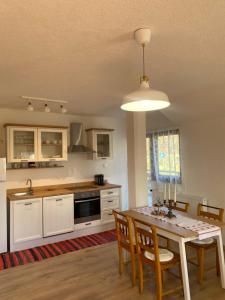a kitchen with a table and some chairs and a table and a kitchen at Apartman Kremen in Kuterevo