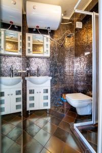 a bathroom with two sinks and a toilet at Spacious apartment in the heart of Studentski grad in Sofia +67 photos
