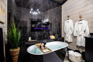 a bathroom with a large tub and a sink at Enchanting Escape for Two in Broken Bow +37 photos