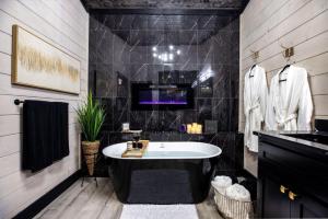 a bathroom with a large tub and a sink at Enchanting Escape for Two in Broken Bow