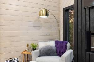 a living room with a chair and a lamp at Enchanting Escape for Two in Broken Bow