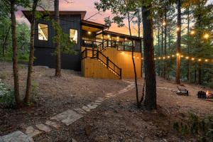 a house in the woods with lights on it at Enchanting Escape for Two in Broken Bow