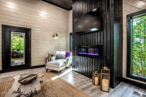 a living room with a chair and a tv at Enchanting Escape for Two in Broken Bow