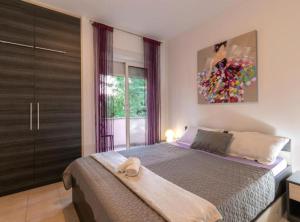 a bedroom with a bed and a painting on the wall at M&B Green Oasis with pool and jacuzzi in Bibinje +61 photos