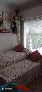 1 cama con 2 almohadas en un dormitorio con ventana en Alojamiento Ruizo, en Lorca