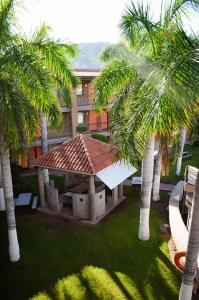 a building with palm trees in front of a building at Hotel Colonial Hermosillo in Hermosillo