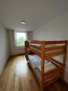 two bunk beds in a room with a window at Renewed 2 Bedroom Apartment with Parking in Ljubljana