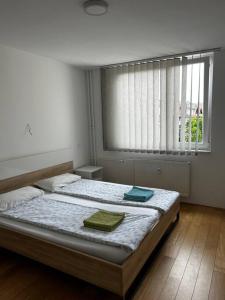 a bedroom with a bed with two towels on it at Renewed 2 Bedroom Apartment with Parking in Ljubljana