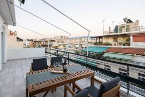 a balcony with a table and chairs on a building at Elektra Suite in Athens