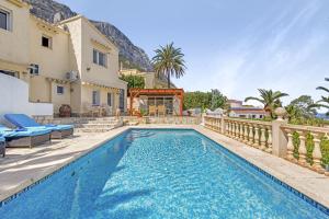 a swimming pool in the backyard of a house at Adriana in Denia