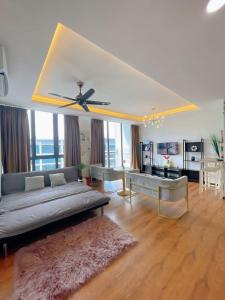 een woonkamer met een bank en een plafondventilator bij Vivacity Apartment Kuching Jazz 2 125 in Kuching