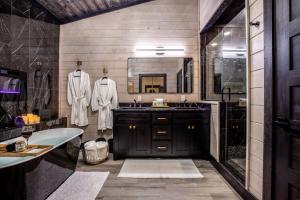 a bathroom with a sink and a tub and a mirror at Enchanting Escape for Two in Broken Bow