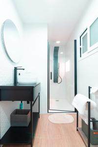 een badkamer met een wastafel en een douche bij EDomus Duque Boutique in Sevilla