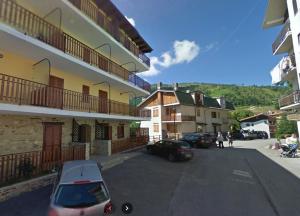 a car parked in a parking lot next to a building at Delizioso Bilocale San Giacomo di Roburent in San Giacomo