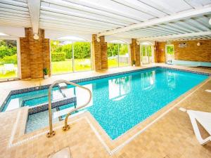 a large swimming pool in a house with a swimming pool at Crofton House Hotel in Torquay