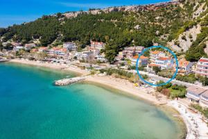 an aerial view of a beach with a blue circle at New Luxury Beach Villa in Duće