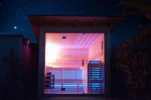 a room with a window with purple lights on it at Baita Fanti Ski & Bike in Bormio