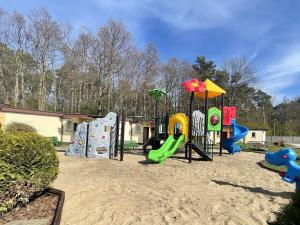 a playground with several different types of playground equipment at A cozy house close to the beach, azy in Łazy