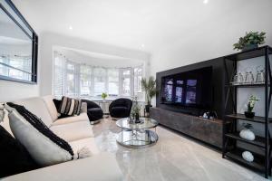a living room with a couch and a table at Hububb Luxury Eastcote in Eastcote