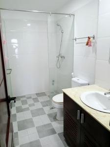 a bathroom with a shower and a toilet and a sink at HOMESTAY Kiwi in Nha Trang