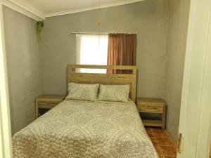 a bedroom with a bed and a window at Home Sweet Home in Polokwane