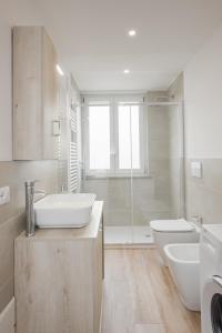 La salle de bains blanche est pourvue d'un lavabo et de toilettes. dans l'établissement Flats4rent Chiara, à Vérone