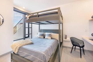 una camera da letto con un letto a castello e una sedia di Luxury Seafront Residence in Boutique Development a El Pescadero Altre 36 foto