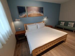a bedroom with a large bed with white sheets at Water World Diving Resort in Green Island
