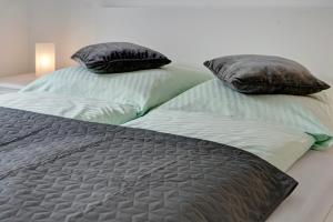 two beds with pillows on them in a bedroom at Wohnung Abendrot in Heringsdorf
