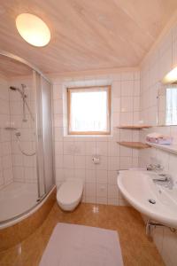 een badkamer met een wastafel, een douche en een toilet bij Gästehaus Rettenbacher in Fulpmes