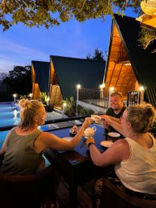 a group of people sitting at a table eating food at Sundown Lake Hotel & Spa in Habarana