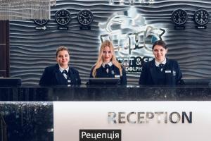 a group of four people sitting at a table at NEMO Hotel Resort & SPA in Odesa