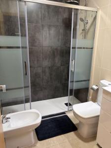 a bathroom with a shower with a toilet and a sink at Family Relax Salou in Salou